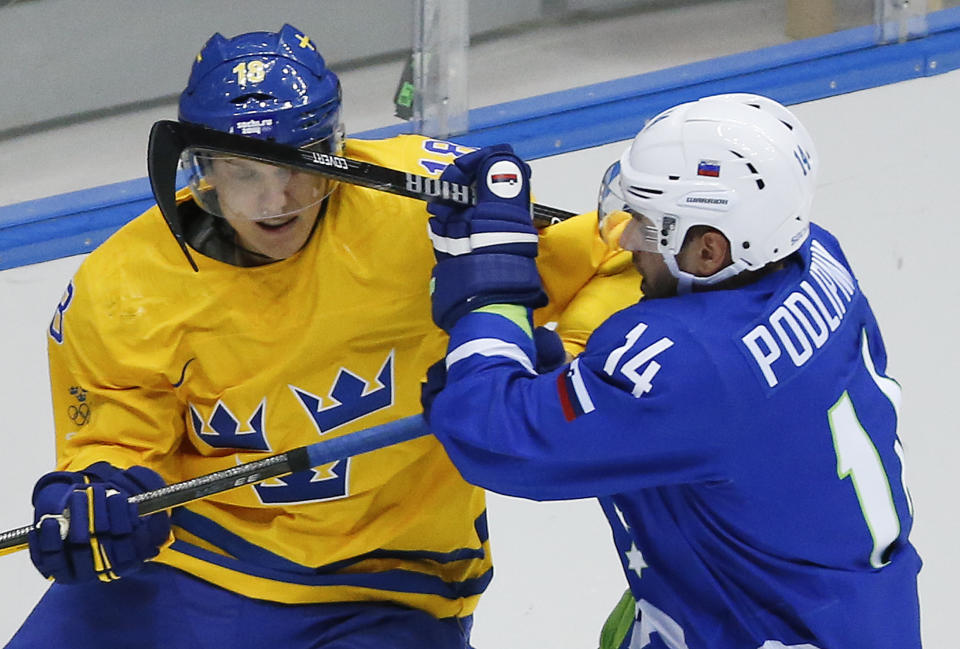 Sweden forward Jakob Silfverberg, left, scrambles against Sovenia defenseman Matic Podlipnik in the third period of a men's ice hockey game at the 2014 Winter Olympics, Wednesday, Feb. 19, 2014, in Sochi, Russia. Sweden won 5-0. (AP Photo/Mark Humphrey)