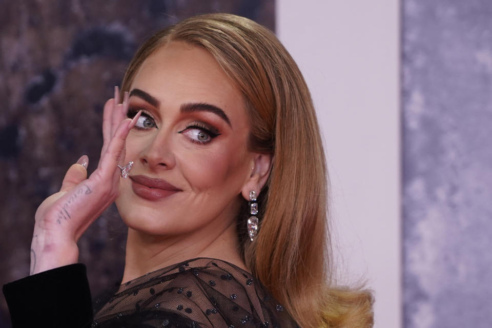 British singer Adele Laurie Blue Adkins aka Adele poses on the red carpet upon her arrival for the BRIT Awards 2022 in London on February 8, 2022. - RESTRICTED TO EDITORIAL USE  NO POSTERS  NO MERCHANDISE NO USE IN PUBLICATIONS DEVOTED TO ARTISTS (Photo by Niklas HALLE'N / AFP) / RESTRICTED TO EDITORIAL USE  NO POSTERS  NO MERCHANDISE NO USE IN PUBLICATIONS DEVOTED TO ARTISTS (Photo by NIKLAS HALLE'N/AFP via Getty Images)