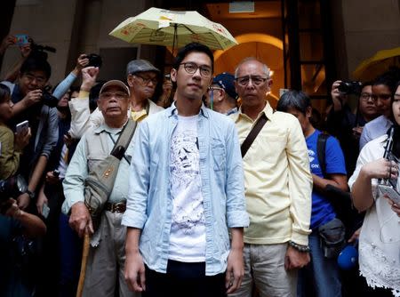 Pro-democracy activist Nathan Law, accompanied by supporters, walks out of the Final Court of Appeal after being granted bail in Hong Kong, China October 24, 2017. REUTERS/Bobby Yip