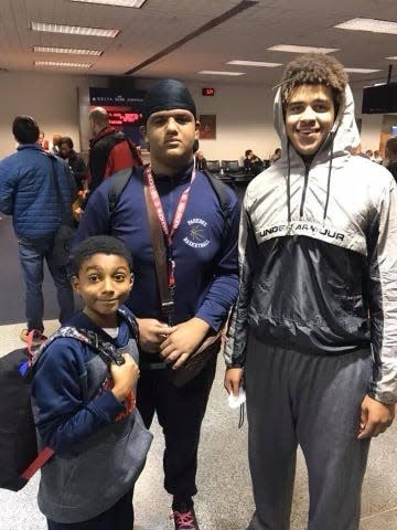 Charles Turner III, right, poses for a picture at Cleveland Hopkins International Airport with Antonio Hall (not in the picture) and his two sons Nicholas, middle, and Noah, bottom left, in 2018.