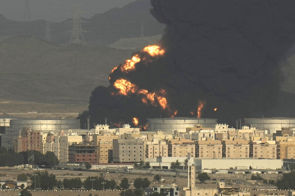 FILE - Plumes of smoke rise from a burning oil depot after an attack by Yemen's Houthi rebels ahead of a Formula One race in Jiddah, Saudi Arabia, Friday, March 25, 2022. Whether trying to find jobs for a growing number of unemployed youth or finding a way to end the long war he launched in Yemen against the Houthis, Crown Prince Mohammed bin Salman and his father King Salman now face a potential pivot point for the kingdom amid Russia's war on Ukraine. (AP Photo/Hassan Ammar, File)