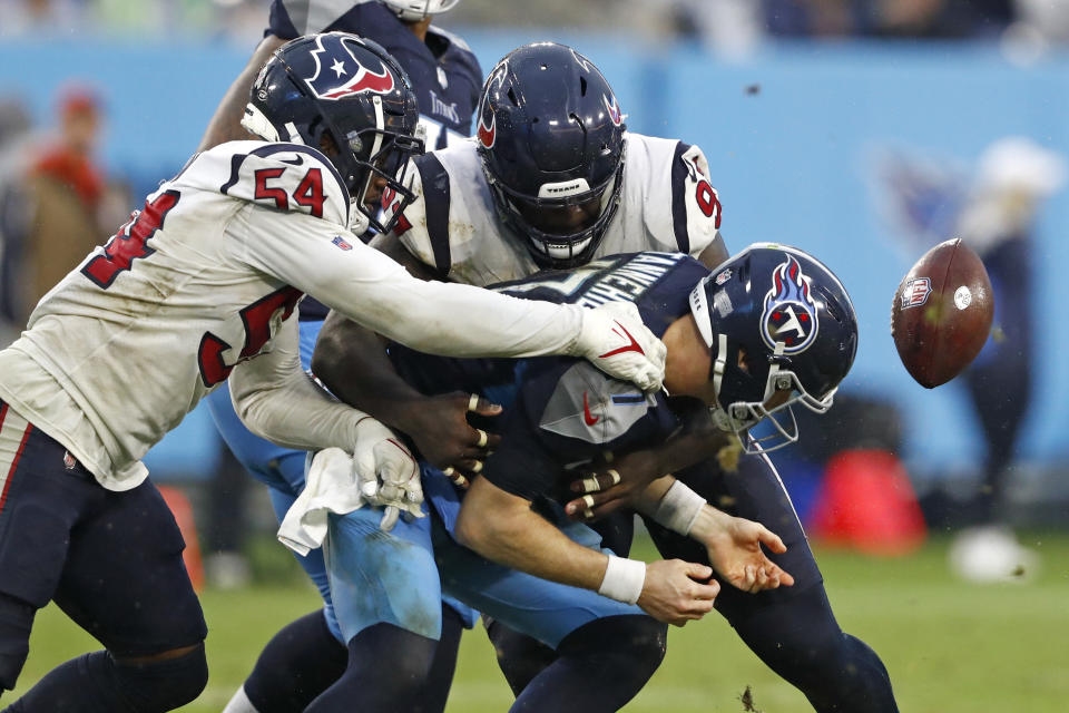 Tennessee Titans quarterback Ryan Tannehill (17) fumbles the ball as he is hit by Houston Texans defensive end Jacob Martin (54) in the second half of an NFL football game Sunday, Nov. 21, 2021, in Nashville, Tenn. (AP Photo/Wade Payne)