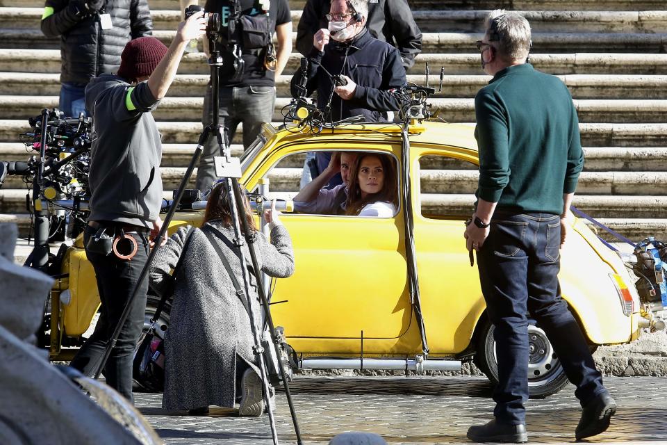 Actor Tom Cruise and actress Hayley Atwell in a Fiat yellow 500 driven by a stuntman, during a an action scene on the set of the film Mission Impossible 7 at Spagna square, just under the Spanish steps. Rome (Italy), November 22nd 2020 (Photo by Samantha Zucchi/Insidefoto/Mondadori Portfolio via Getty Images)