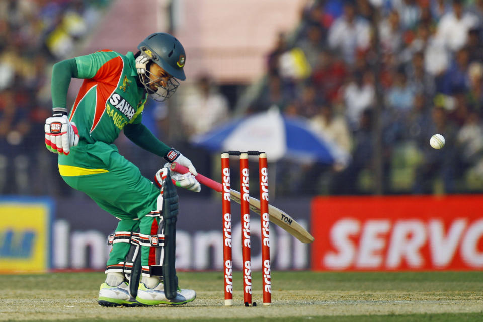 Bangladesh's Mushfiqur Rahim reacts in pain after he was hit by a ball during the Asia Cup one-day international cricket tournament against India in Fatullah, near Dhaka, Bangladesh, Wednesday, Feb. 26, 2014. (AP Photo/A.M. Ahad)