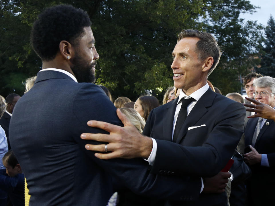 Steve Nash, right, greets Kyrie Irving on the red carpet before induction ceremonies into the Basketball Hall of Fame, Friday, Sept. 7, 2018, in Springfield, Mass. (AP Photo/Elise Amendola)