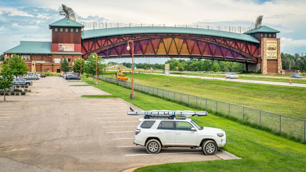 Kearney, NE, USA - July 30, 2018: Toyota 4Runner SUV (2016 trail model) with a stand up paddleboard on rood racks in front of Great Platte River Road Archway Monument.