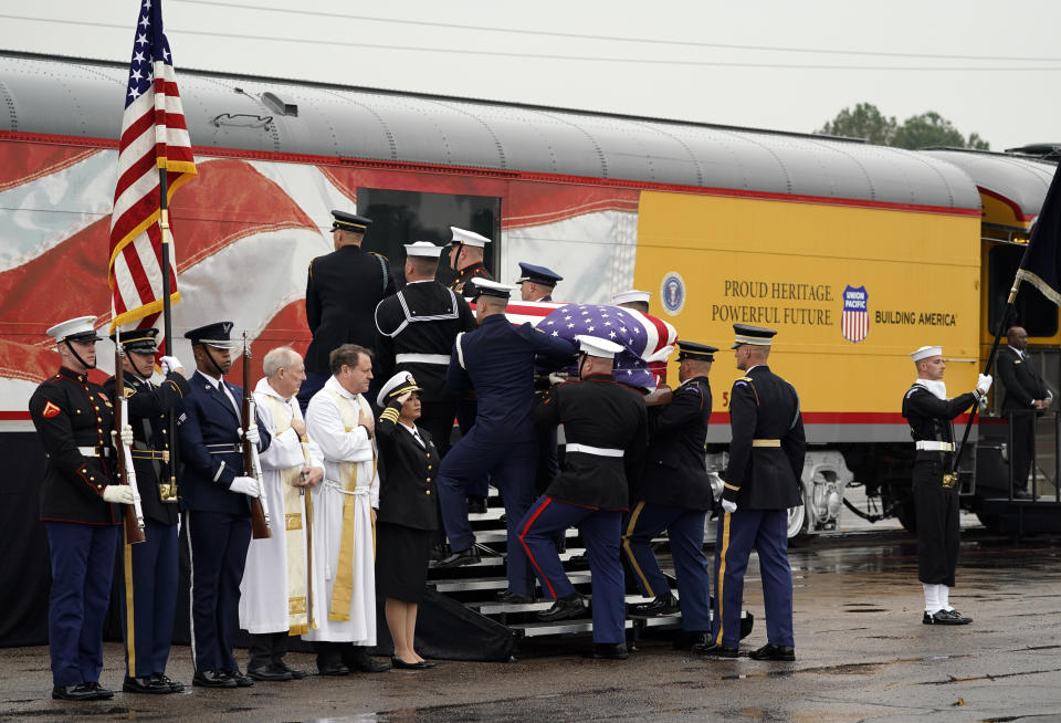 The flag-draped casket of former President George H.W. Bush is carried by a joint services military honor guard Thursday, Dec. 6, 2018, in Spring, Texas, as it is placed on a Union Pacific train.(Photo: David J. Phillip, Pool/AP)
