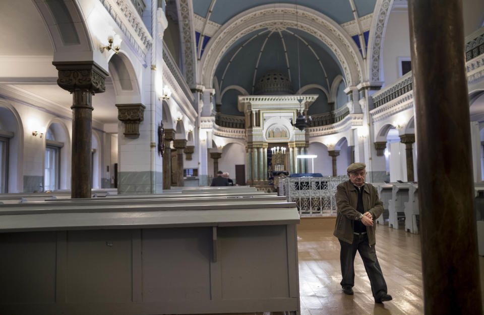 In this photo taken on Monday, Nov. 4, 2018, Lithuanian Jewish man coming out of the Synagogue in Vilnius, Lithuania. Jewish leaders in the Lithuanian capital are closing the city’s sole synagogue and community center indefinitely following a string of threats sparked by an emotional debate over history. Community leader Faina Kukliansky told The Associated Press on Wednesday, Aug. 7, 2019 that “our community is receiving threatening calls and letters lately. (AP Photo/Mindaugas Kulbis)