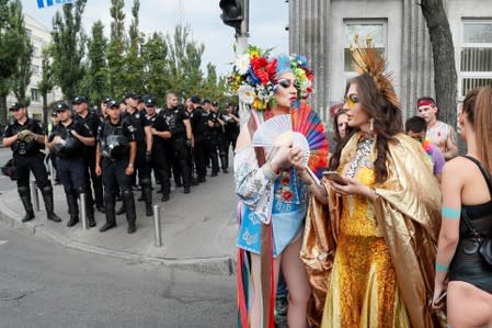 Police officers guard participants of the Equality March, organized by the LGBT community, in Kiev