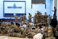 WASHINGTON, DC - JANUARY 13: Members of the National Guard rest in the Visitor Center of the U.S. Capitol on January 13, 2021 in Washington, DC. Security has been increased throughout Washington following the breach of the U.S. Capitol last Wednesday, and leading up to the Presidential inauguration. (Photo by Stefani Reynolds/Getty Images)