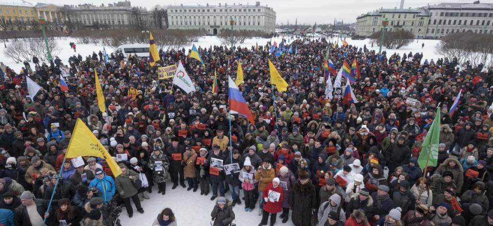 People gather in memory of opposition leader Boris Nemtsov in St. Petersburg, Russia, Sunday, Feb. 26, 2017. Thousands of Russians have taken to the streets of Moscow and St. Petersburg to mark two years since Nemtsov was gunned down outside the Kremlin. (AP Photo/Dmitri Lovetsky)