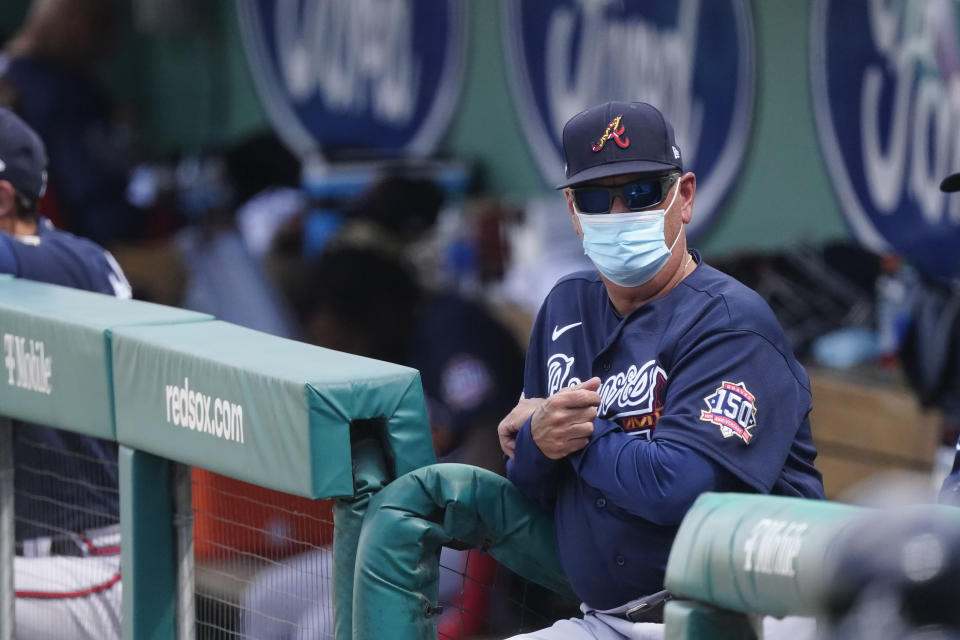 Atlanta Braves manager Brian Snitker watches from the dugout as his team plays the Boston Red Sox in a spring training baseball game Wednesday, March 10, 2021, in Fort Myers, Fla. (AP Photo/John Bazemore)