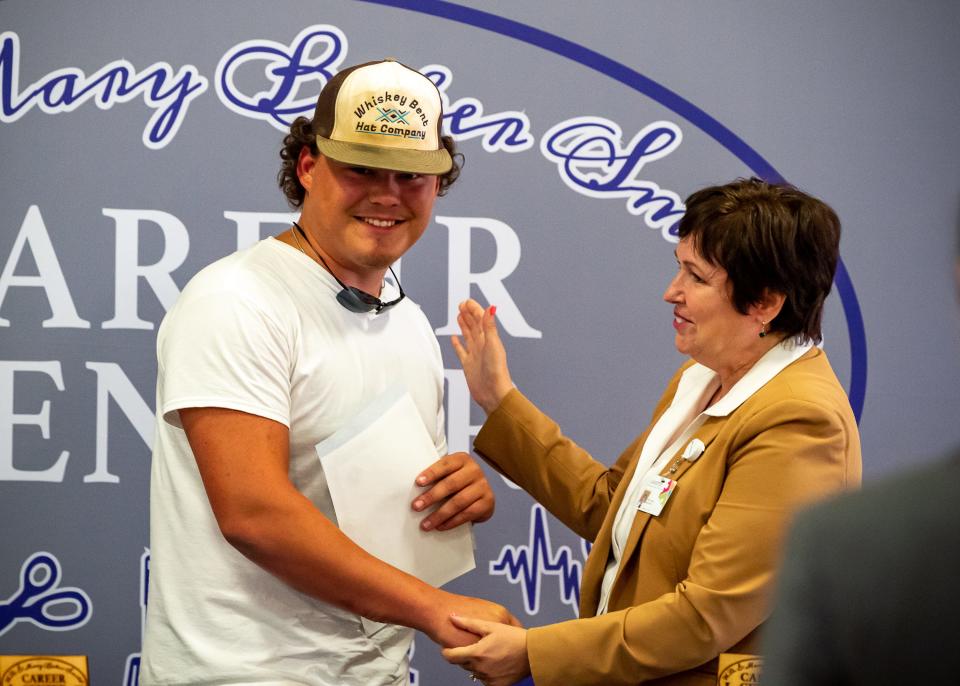 Devin Barrilleaux being congratulated by Superintendent - Irma D. Trosclair during Signing ceremony where Career Center students' sign on with future employers going directly into the workforce after graduation. Wednesday, May 4, 2022.