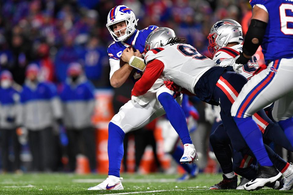 Bills quarterback Josh Allen is tackled by the Patriots' Matt Judon.