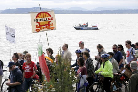 A police boat patrols as activists protest the Polar Pioneer, an oil rig leased by Royal Dutch Shell Plc that is bound for the Arctic, at a rally and march in Seattle, Washington, United States April 26, 2015. REUTERS/Jason Redmond
