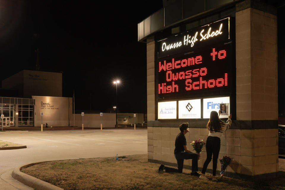 Juanpablo Alvarez and Karla Alvarez place flowers at a memorial (Shelby Tauber for NBC News)