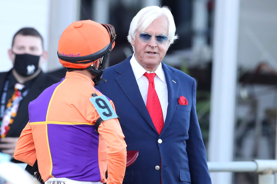 Trainer Bob Baffert talks with jockey John Velazquez after the Preakness Stakes in 2020.