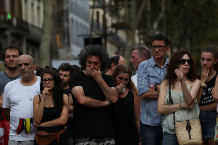 People react at an impromptu memorial where a van crashed into pedestrians at Las Ramblas in Barcelona, Spain, August 19, 2017. REUTERS/Sergio Perez