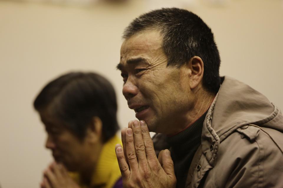 A relative of a passenger onboard Malaysia Airlines Flight MH370 cries prays at a praying room in Beijing