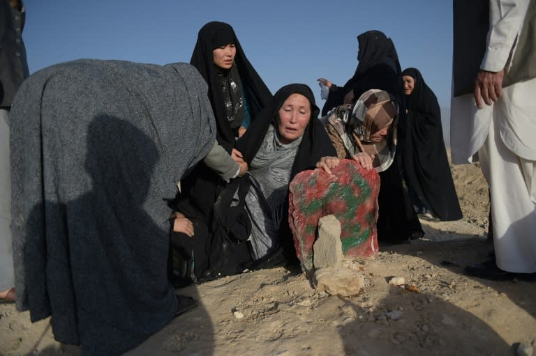 An elderly mother (C) mourns at the grave of her son who was killed in a twin suicide attack in Kabul, on July 25, 2016