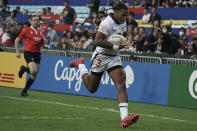 David Still of United States runs to score a try against Spain during the first day of the Hong Kong Sevens rugby tournament in Hong Kong, Friday, Nov. 4, 2022. The Hong Kong Sevens, a popular stop on the World Rugby Sevens Series circuit, is part of the government's drive to restore the city's image as a vibrant financial hub after it scrapped mandatory hotel quarantine for travelers. (AP Photo/Anthony Kwan)