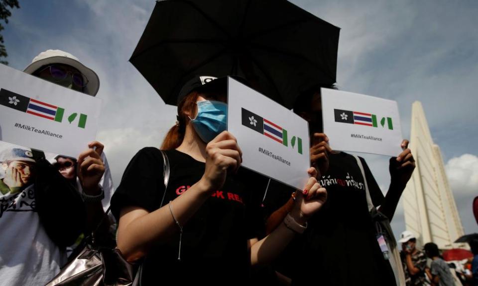 Protesters hold signs of the Hong Kong-Thailand-Taiwan network (Milk Tea Alliance) during a rally to demand the government to resign