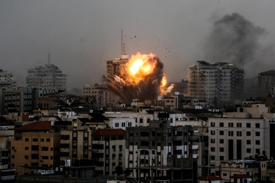 A smoke rises and ball of fire over a buildings in Gaza City on October 9, 2023 during an Israeli air strike.
