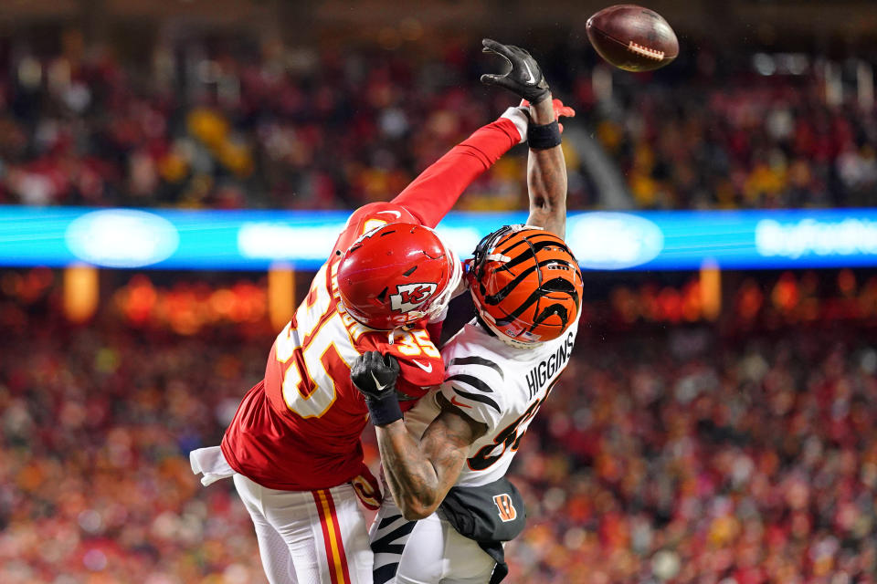 Jan 29, 2023; Kansas City, Missouri, USA; Kansas City Chiefs cornerback Jaylen Watson (35) battles for a pass against Cincinnati Bengals wide receiver Tee Higgins (85) during the second quarter of the AFC Championship game at GEHA Field at Arrowhead Stadium. Mandatory Credit: Jay Biggerstaff-USA TODAY Sports