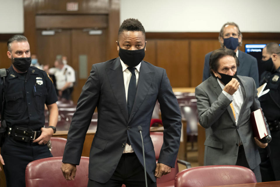 Actor Cuba Gooding Jr., center, approaches the defense table with his lawyer Marc Heller, foreground right, during a hearing in his sexual misconduct case, Thursday, Aug. 13, 2020, in New York. A judge ordered the courtroom outfitted with Plexiglas and other measures to prevent the spread of the coronavirus, which has delayed the trial indefinitely. (Steven Hirsch/New York Post via AP, Pool)