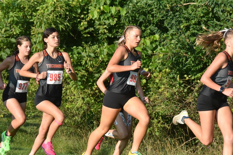 Tecumseh's Kaylee Hicks (977), Jessica Warren (985) and Maya Whelan (986) run together at Saturday's Lenawee County Cross Country Preview on their home course.