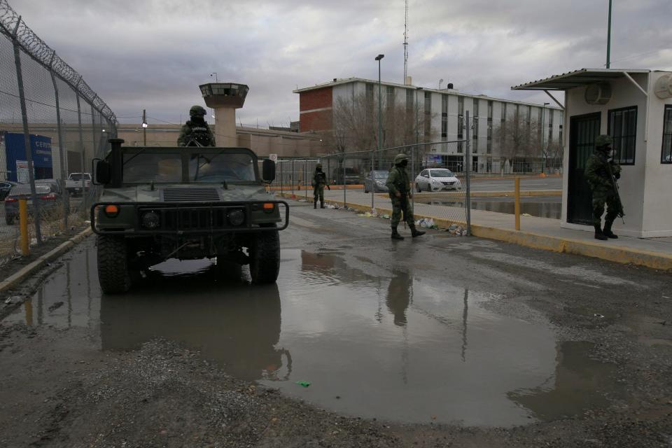 Soldiers guard the the Cereso No. 3 state prison in Juárez after inmates escaped in a breakout Sunday. Two officers were killed Monday in a battle with gunmen believed to be involved in the escape. Five gunmen also were killed.