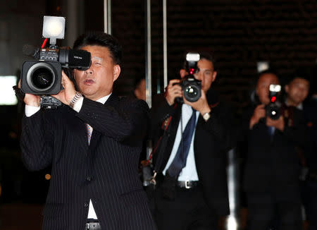 Cameramen run as they film the people waiting for the arrival of North Korea's leader Kim Jong Un at The Marina Bay Sands hotel in Singapore, June 11, 2018. REUTERS/Edgar Su