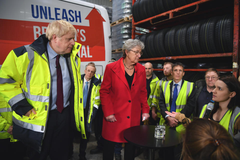 A member of staff Page Hood, right, asks Britain's Prime Minister Boris Johnson, left, a question regarding fake news websites during a question and answer session, part of a General Election campaign visit to Ferguson's Transport in Washington, England, Monday, Dec. 9, 2019. Britain goes to the polls on Dec. 12. (Ben Stansall/Pool Photo via AP)