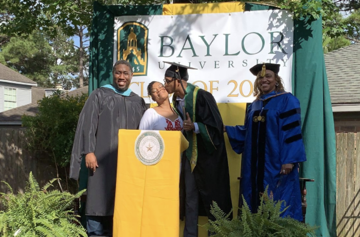 Derrick Williams kisses his mom, Ayanna Tatum, after she threw him a surprise graduation in their backyard. (Photo: Courtesy of Ayanna Tatum)