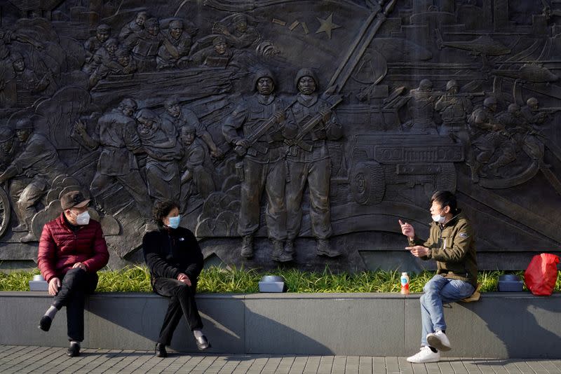 People wearing masks are seen at a main shopping area, in downtown Shanghai