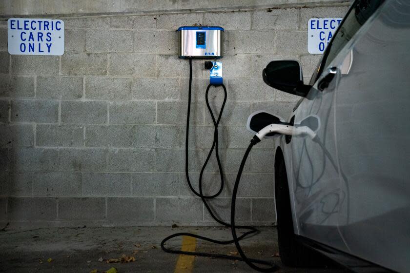 KOKOMO, IN - OCTOBER 25: An electric vehicle (EV) charging station in a parking garage in downtown Kokomo on Tuesday, Oct. 25, 2022 in Kokomo, IN. Kokomo is known as the "City of Firsts,"as a significant number of technical and engineering innovations were developed in Kokomo, particularly in automobile production - which a large portion of the city's employment still relies upon. (Kent Nishimura / Los Angeles Times)