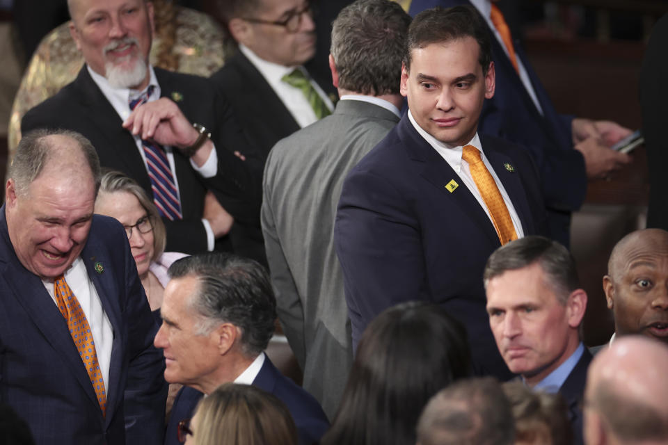 Rep. George Santos, top right, looking in the direction of Sen. Mitt Romney, R-Utah, bottom left, at a joint session of Congress.