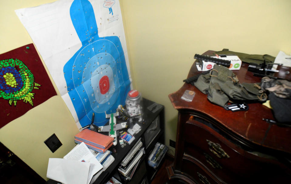 This image contained in Justice Department motion for continued pretrial detention of Jack Teixeira, shows his room at his father's home in North Dighton, Mass. A judge has put off a decision on whether the Massachusetts Air National guardsman accused of leaking highly classified military documents should be held in jail until his trial. Prosecutors said Teixeira kept an arsenal of weapons and said on social media that he would like to kill a "ton of people." (Justice Department via AP)