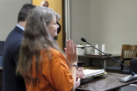 Deborah Leonard raises her hand as she gives testimony in the death of her son Lucas Leonard at Oneida County Court in Utica, New York, December 2, 2015. REUTERS/TG Branfalt Jr.