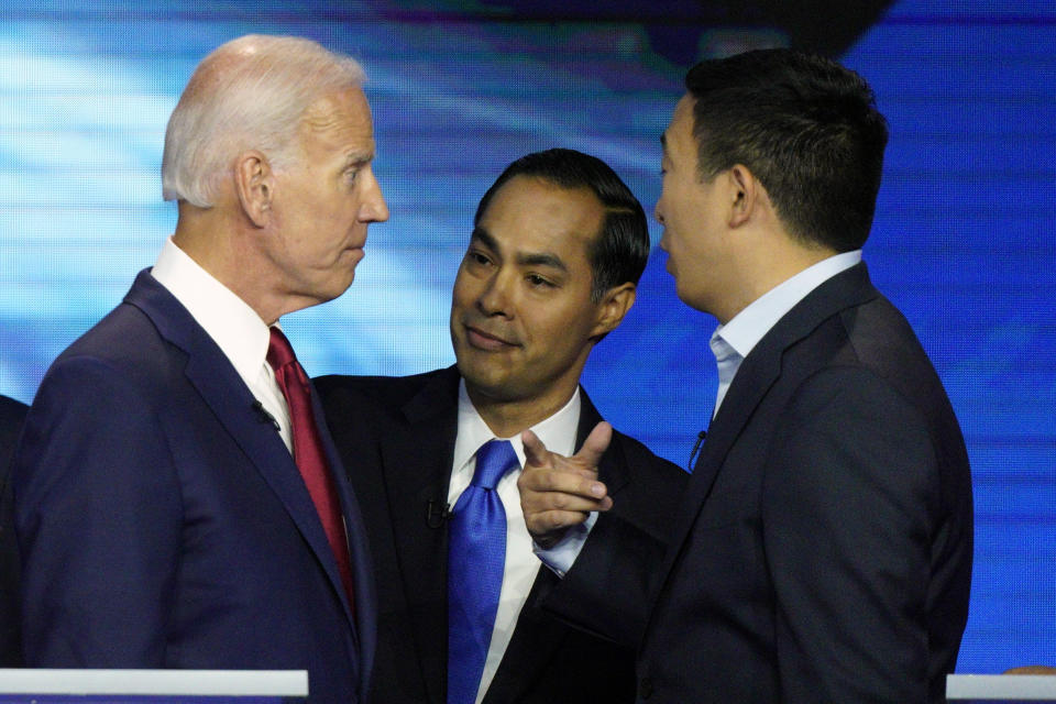 Democratic presidential candidates former Vice President Joe Biden, former Housing and Urban Development Secretary Julian Castro, and Andrew Yang talk Thursday, Sept. 12, 2019, after a Democratic presidential primary debate hosted by ABC at Texas Southern University in Houston. (AP Photo/David J. Phillip)