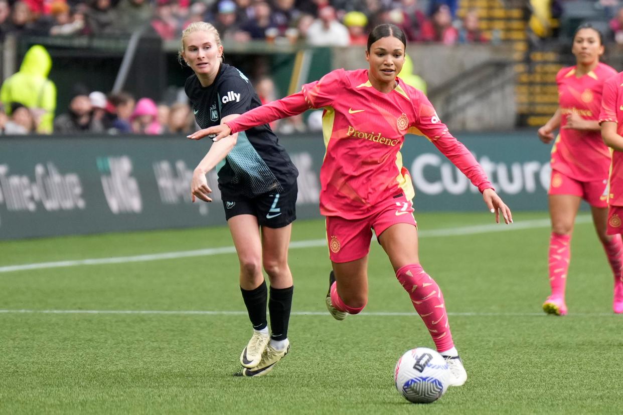 The Portland Thorns' Sophia Smith and NJ/NY Gotham FC's Jenna Nighswonger battle for the ball at Providence Park on March 24, 2024.