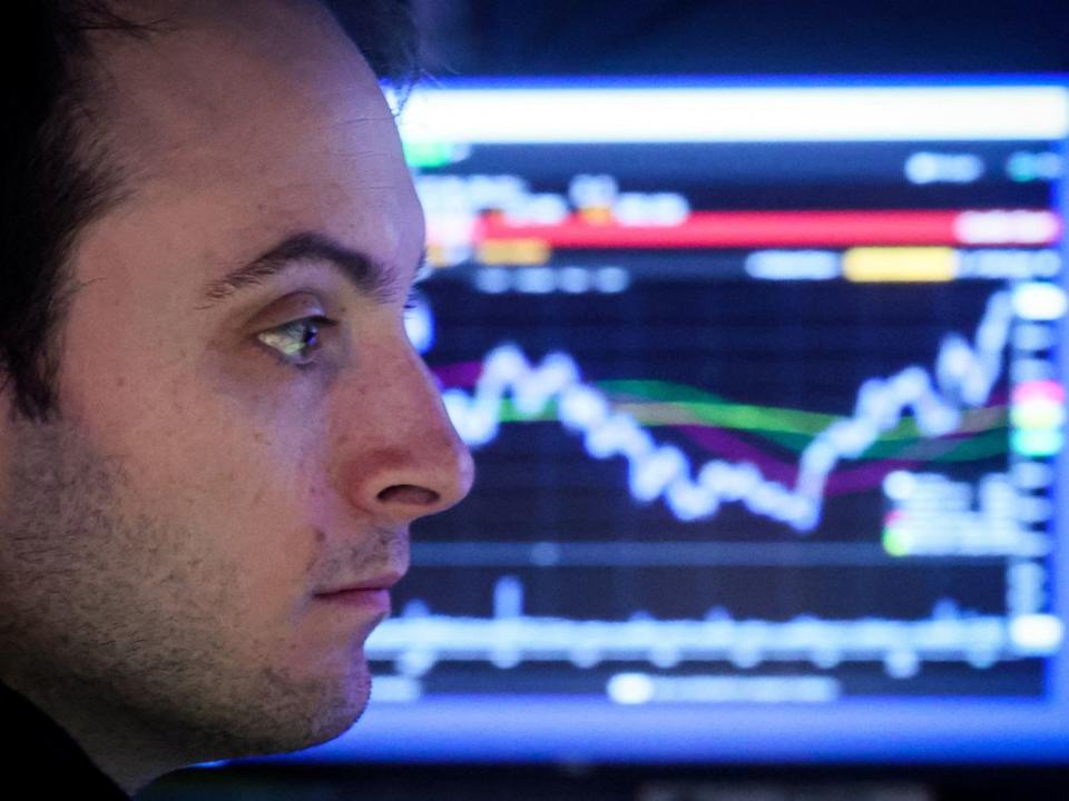 Traders work on the floor of the NYSE in New York