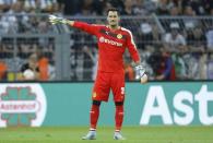 Borussia Dortmund's goalkeeper Roman Burki gestures to his team mates during their Bundesliga first division soccer match against Borussia Moenchengladbach in Gelsenkirchen, Germany August 15, 2015. REUTERS/Ina Fassbender