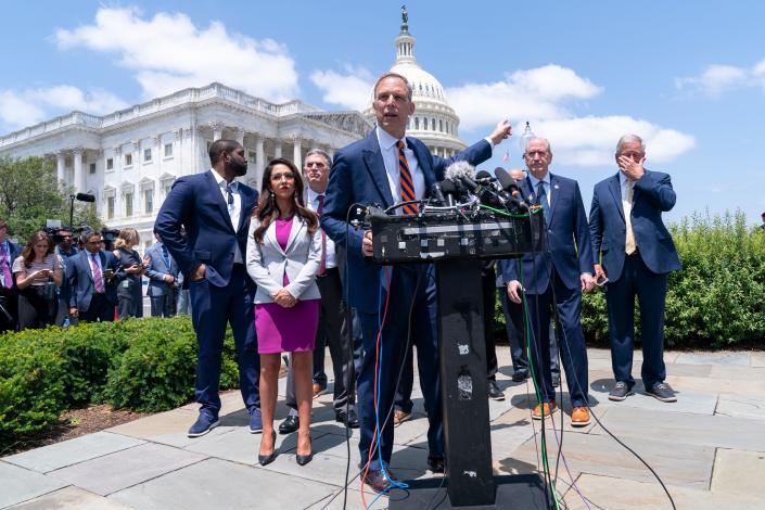 Rep. Scott Perry, R-Pa., gestures toward the Capitol during a press conference with members of the conservative House Freedom Caucus, regarding the debt limitation agreement, Tuesday, May 30, 2023, on Capitol Hill in Washington.  (AP Photo/Jacquelyn Martin) XMIT ORG: DCJM107