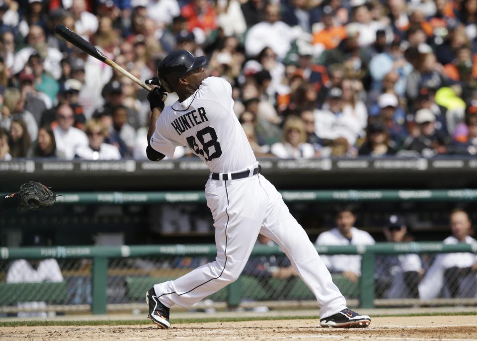 Detroit Tigers' Torii Hunter watches his solo home run off Baltimore Orioles starting pitcher Chris Tillman during the fourth inning of a baseball game in Detroit, Sunday, April 6, 2014. (AP Photo/Carlos Osorio)