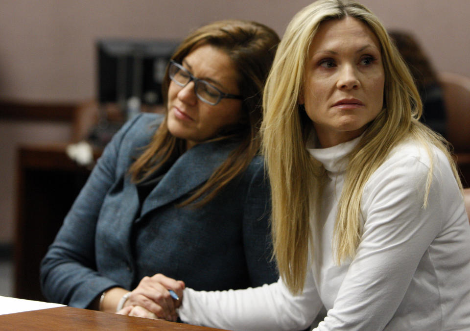 Attorney Ellen Torregrossa-O'Connor, left, holds the hand of former "Melrose Place" actress Amy Locane-Bovenizer, 40, of Hopewell Township, N.J. as the jury in her trial returns a verdict on Tuesday, Nov. 27, 2012 in Somerville, N.J. The jurors convicted Locane-Bovenizer of vehicular homicide, but acquitted her of a more serious charge, aggravated manslaughter, in the 2010 accident that killed a 60-year-old woman. Somerset County prosecutors said Locane-Bovenizer's blood-alcohol level was nearly three times the legal limit when the crash occurred on a dark two-lane road in Montgomery Township. The defence conceded she was driving under the influence. But her lawyer claimed a woman was chasing her after an earlier accident, forcing her to speed. (AP Photo/The Star-Ledger, Robert Sciarrino, Pool)