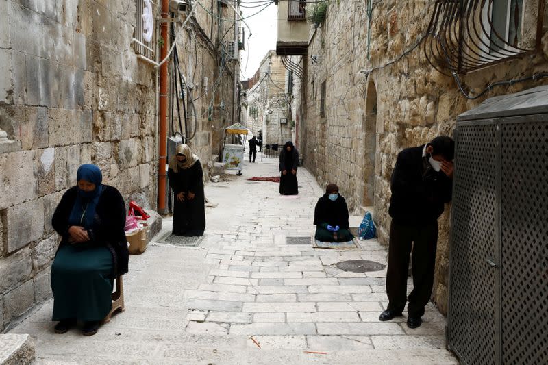 Muslims pray during the first Friday prayer of Ramadan in an alley in Jerusalem's Old City amid the coronavirus disease (COVID-19) restrictions