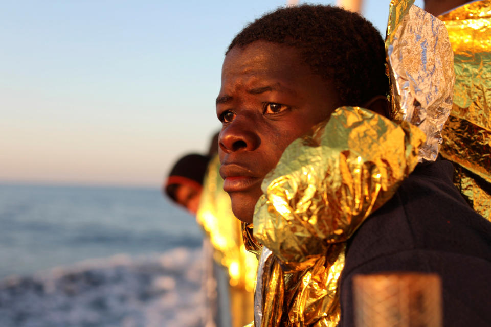 A migrant, covered with a thermal blanket, gazes at the sea aboard a boat operated by the Spanish NGO Proactiva Open Arms following a rescue operation near the coast of Libya on Feb. 3. (Photo: Giorgos Moutafis / Reuters)