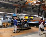 Workers install dashboards in Volkswagen ID.3 cars at the automaker's Zwickau assembly plant in Zwickau