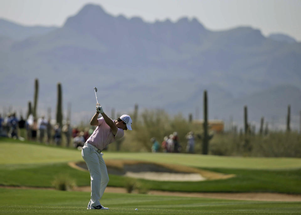 Rory McIlroy, of Northern Ireland, hits from the fairway on the 17th hole during a practice round for the Match Play Championship golf tournament Tuesday, Feb. 18, 2014, in Marana, Ariz. (AP Photo/Chris Carlson)